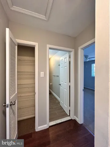 a view of a hallway with wooden floor