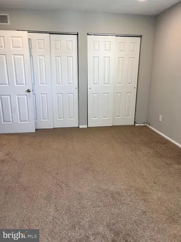 an empty room with white cabinet