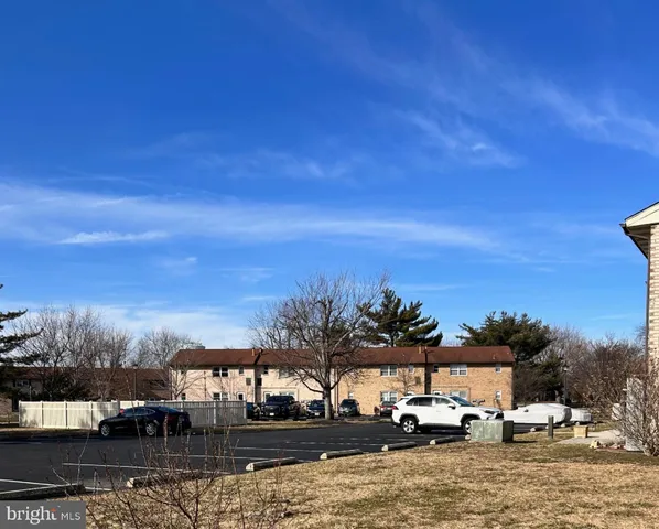 a view of parked cars in front of house