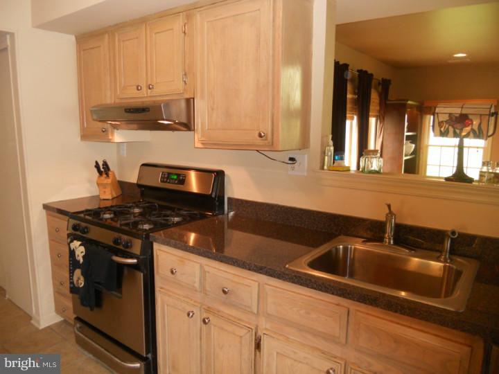 11 Nottingham Road Evesham, NJ 08053 - Photo 4 of 23 a kitchen with granite countertop a sink stove and cabinets