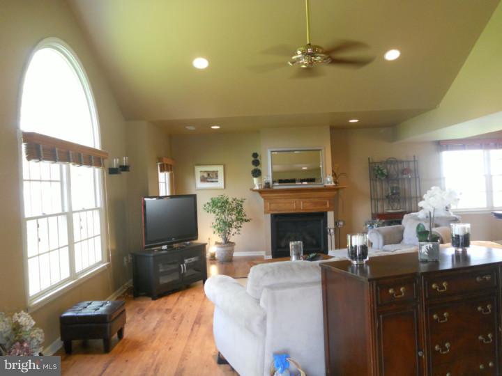11 Nottingham Road Evesham, NJ 08053 - Photo 5 of 23 a living room with furniture a fireplace and a flat screen tv