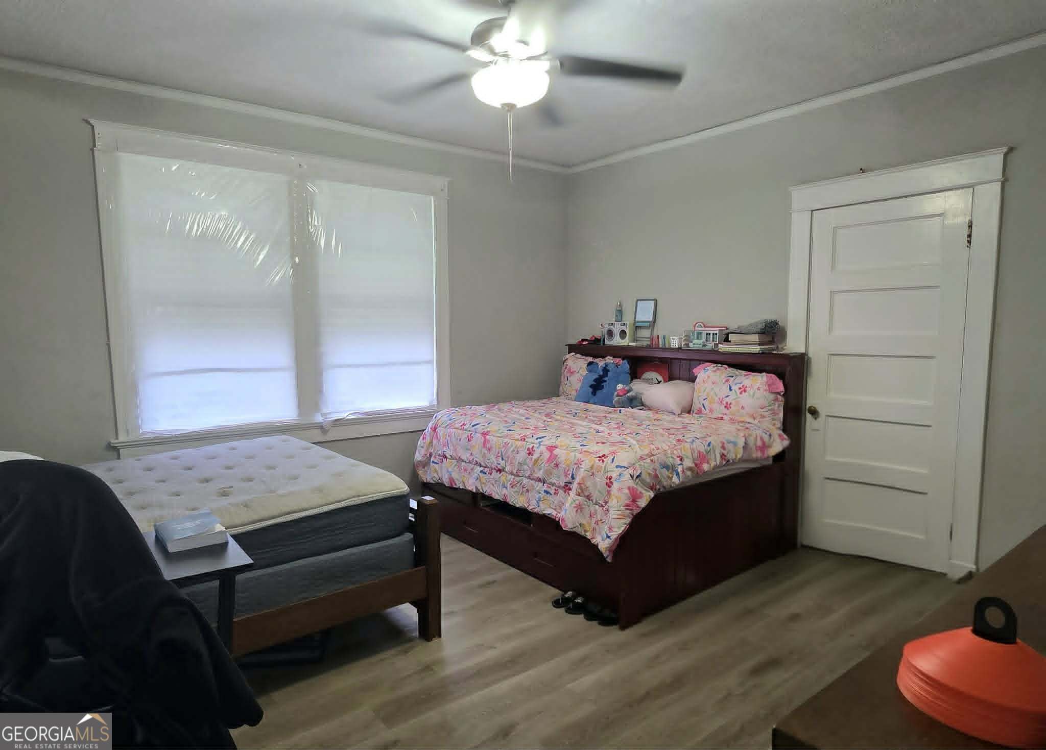 119 O Street Southwest Thomaston, GA 30286 - Photo 5 of 9 a bedroom with a bed and window