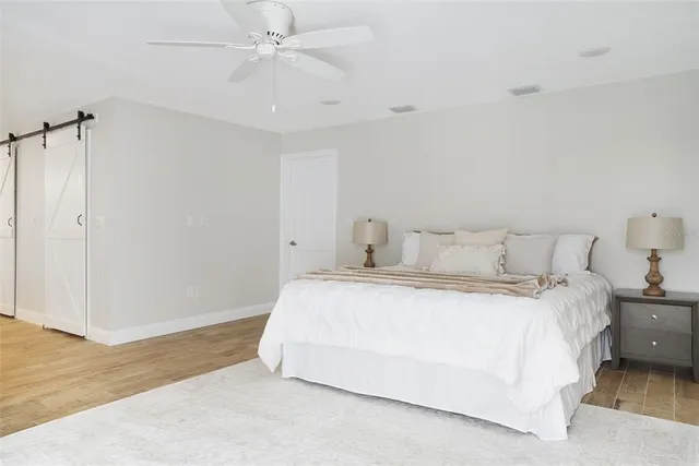 a spacious bedroom with a bed and a couch