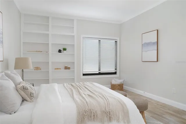 a bedroom with a bed and chair