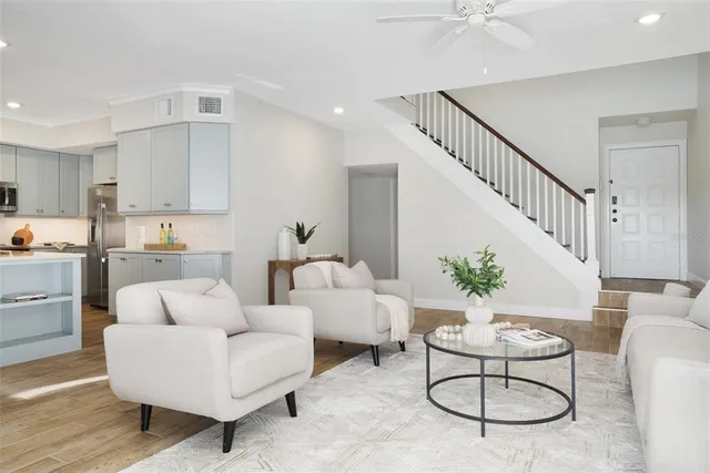 a living room with furniture kitchen view and a table
