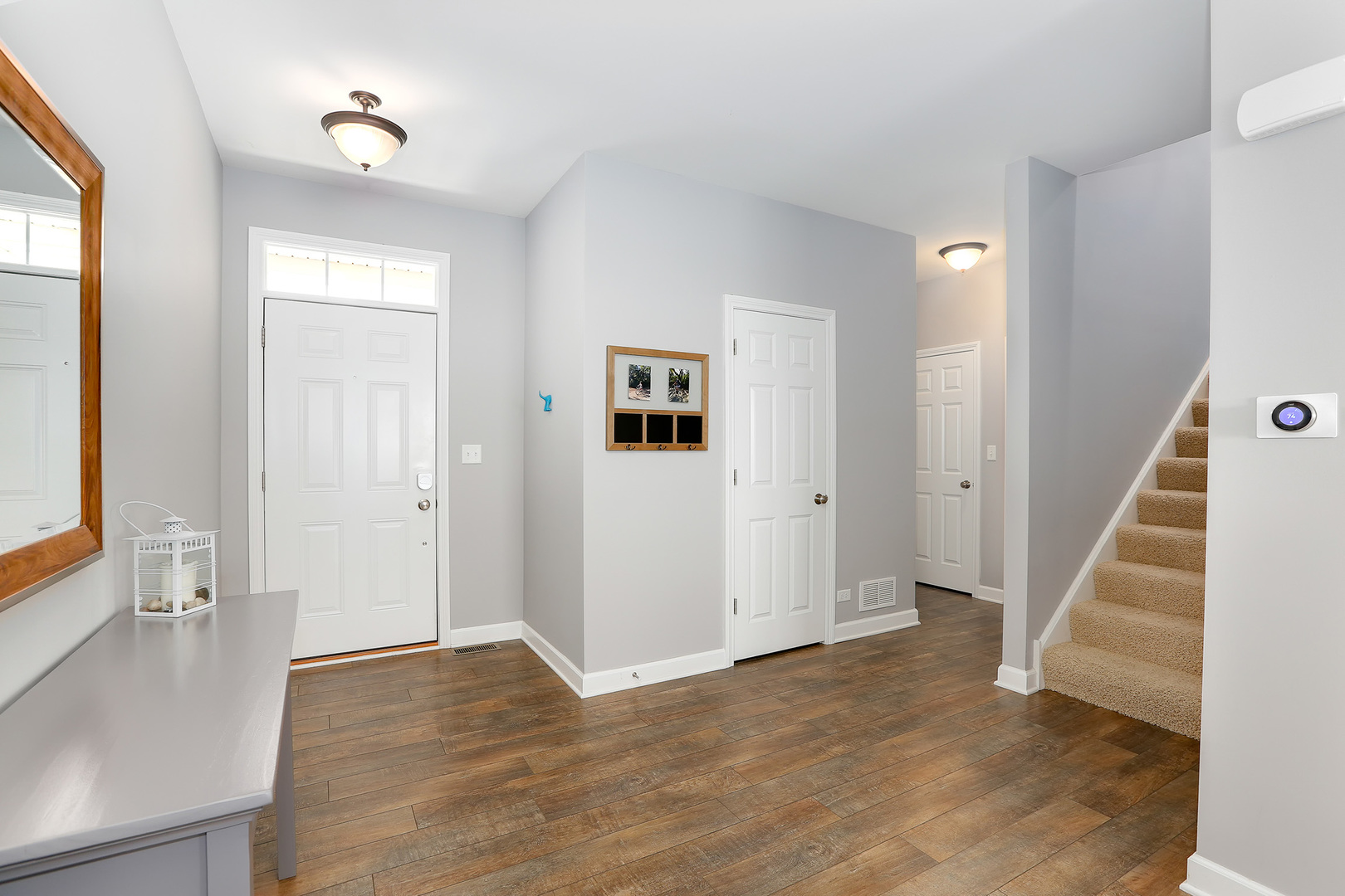 2827 Church Road Aurora, IL 60502 - Photo 4 of 30 a view of a hallway with wooden floor and staircase