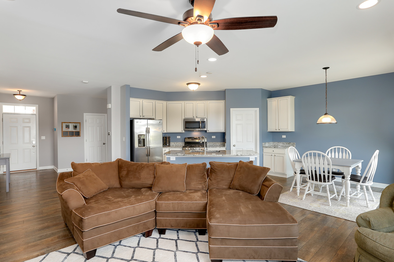 2827 Church Road Aurora, IL 60502 - Photo 8 of 30 a living room with furniture kitchen view and a chandelier
