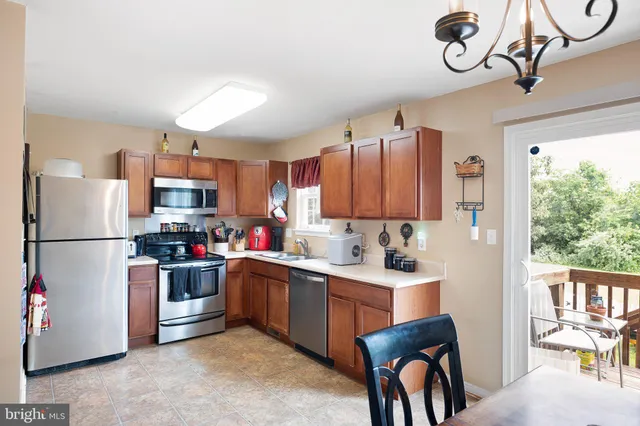 a kitchen with a sink cabinets and stainless steel appliances