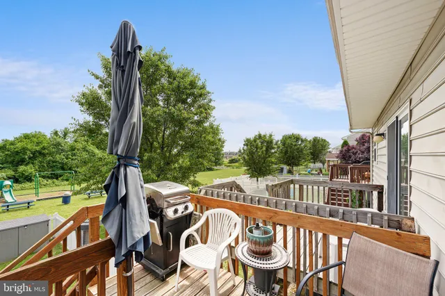 a view of balcony with wooden floor and fence