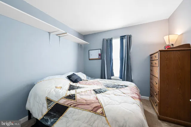 a bedroom with a bed and a lamp