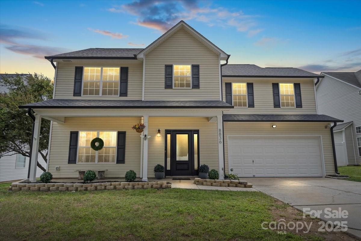 a front view of a house with a yard and garage