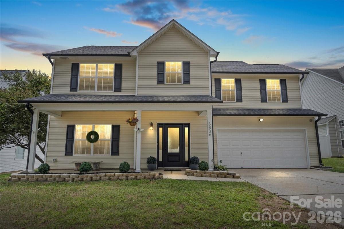 a front view of a house with a yard and garage
