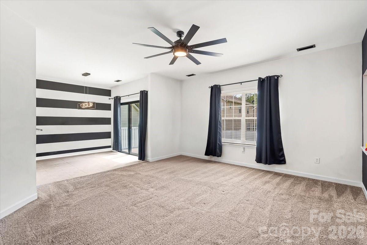8836 Cornwall Street Locust, NC 28097 - Photo 12 of 42 a view of an empty room with a ceiling fan