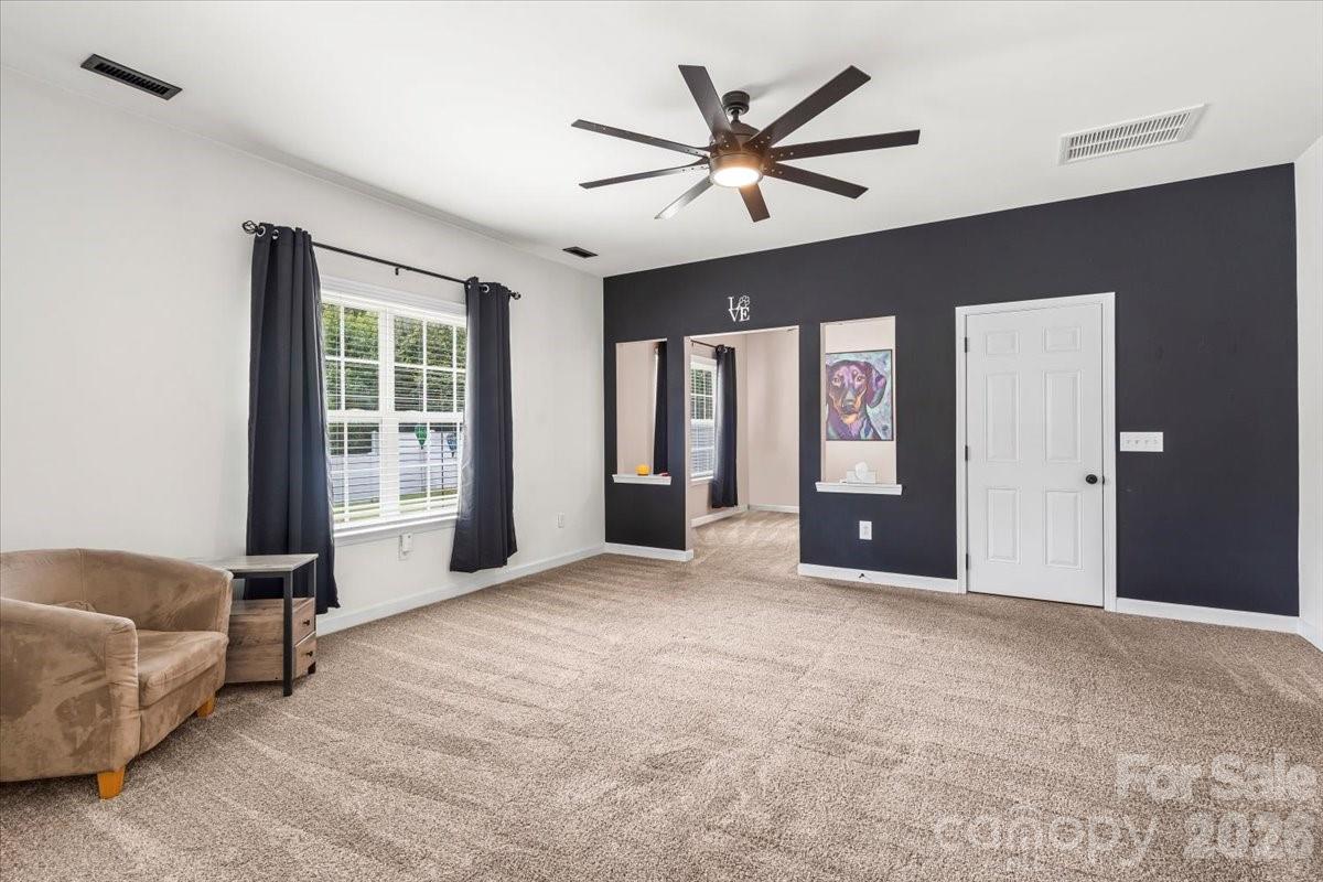 8836 Cornwall Street Locust, NC 28097 - Photo 15 of 42 a view of a livingroom with a ceiling fan and window
