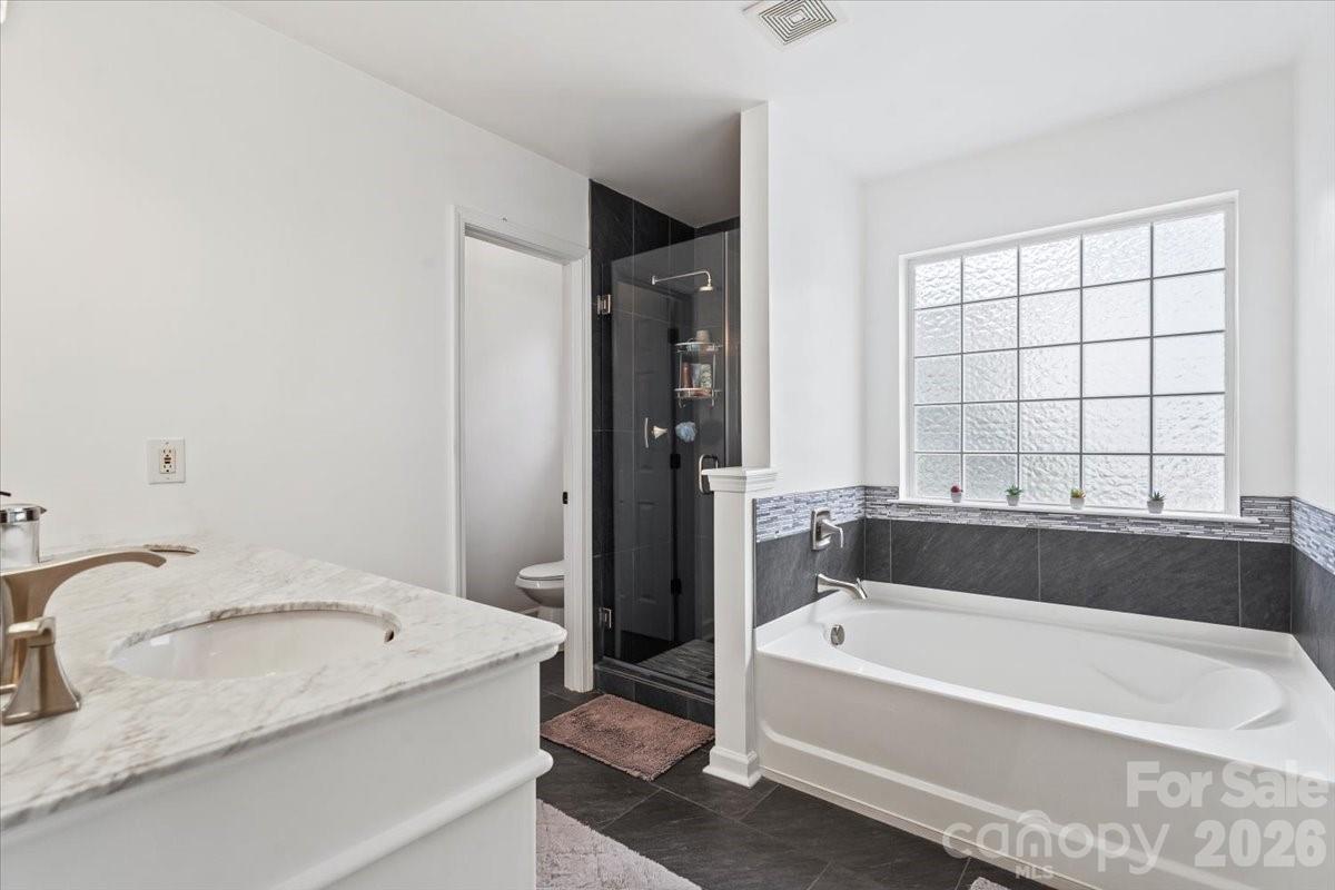 8836 Cornwall Street Locust, NC 28097 - Photo 25 of 42 a bathroom with bathtub and a sink