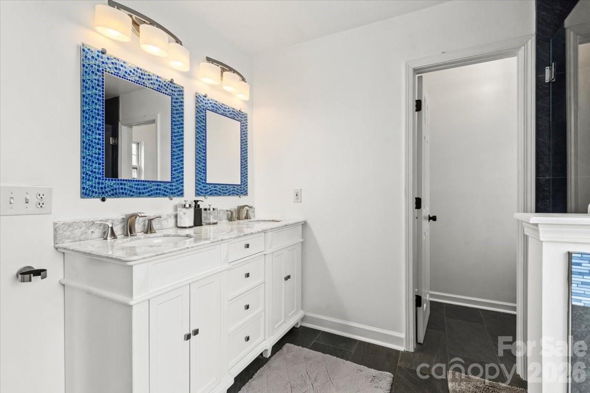 8836 Cornwall Street Locust, NC 28097 - Photo 26 of 42 a bathroom with a sink a light fixture a vanity and a mirror