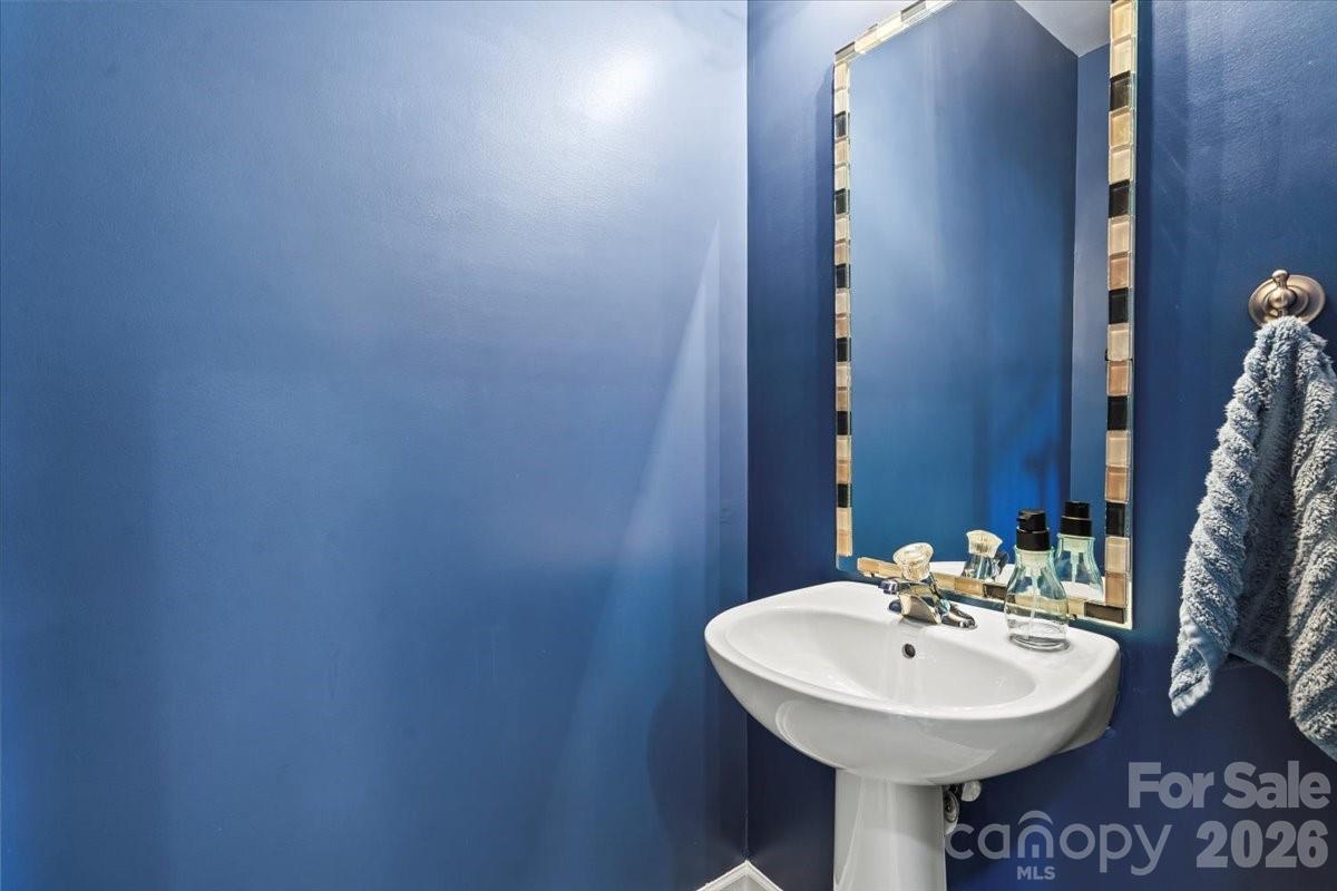 8836 Cornwall Street Locust, NC 28097 - Photo 28 of 42 a sink with a mirror