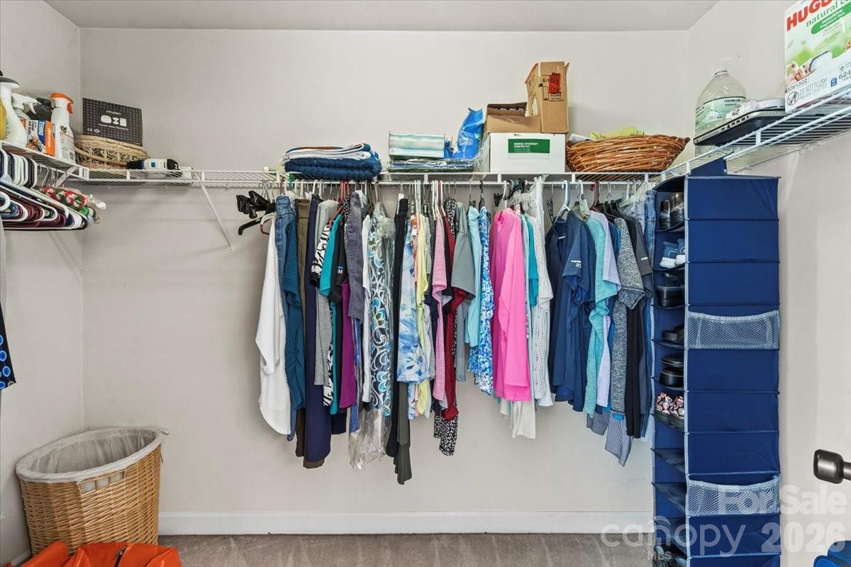 8836 Cornwall Street Locust, NC 28097 - Photo 29 of 42 a view of walk in closet with clothes and shoes