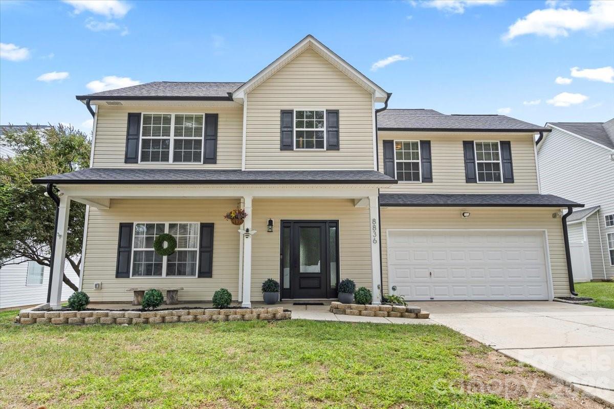8836 Cornwall Street Locust, NC 28097 - Photo 33 of 42 a front view of a house with a yard and garage