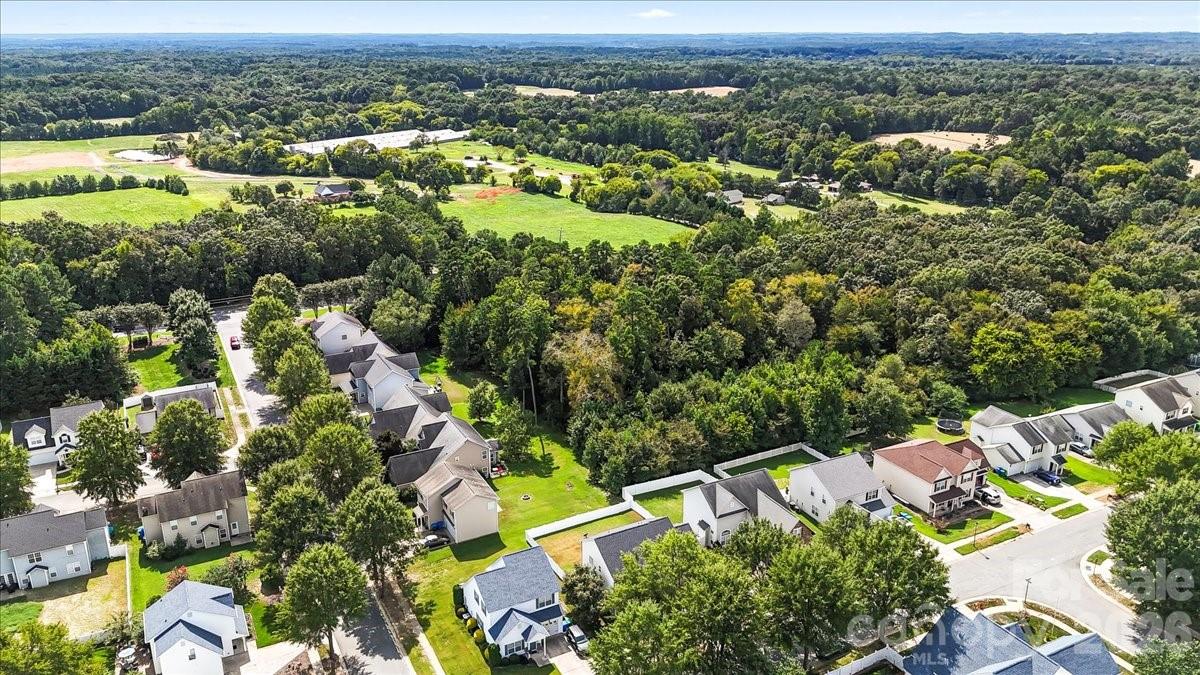 8836 Cornwall Street Locust, NC 28097 - Photo 38 of 42 an aerial view of residential houses with outdoor space and trees