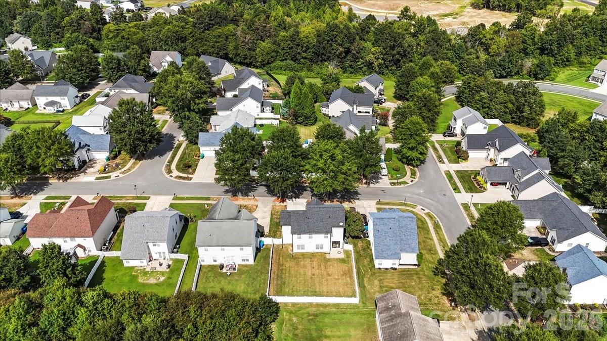 8836 Cornwall Street Locust, NC 28097 - Photo 40 of 42 an aerial view of residential houses with outdoor space and swimming pool