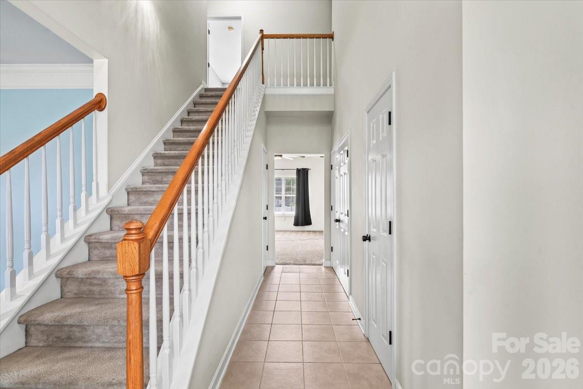 8836 Cornwall Street Locust, NC 28097 - Photo 4 of 42 a view of a hallway with wooden floor and staircase