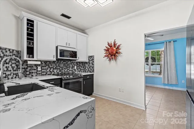 a kitchen with a stove sink and microwave