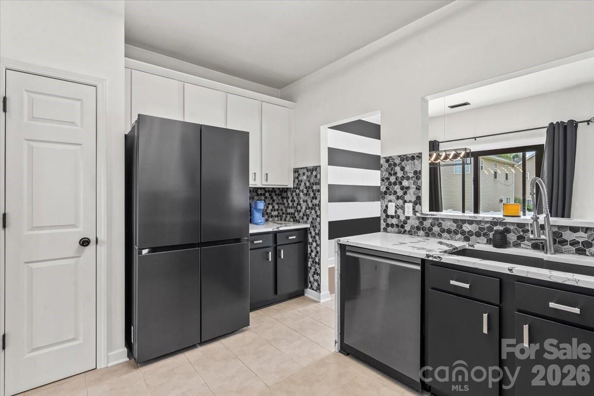 8836 Cornwall Street Locust, NC 28097 - Photo 10 of 42 a kitchen with stainless steel appliances granite countertop a refrigerator and a sink