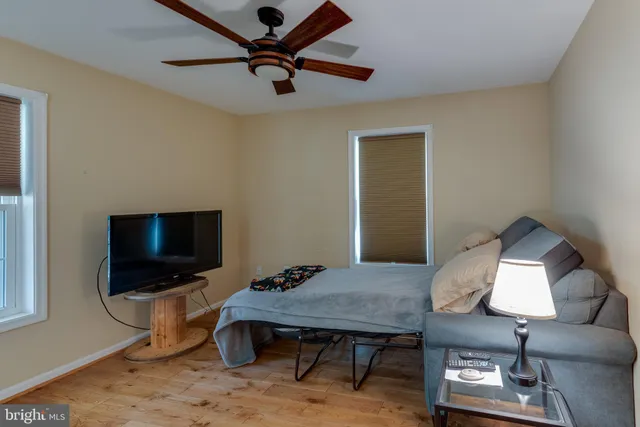 a bedroom with furniture and a wooden floor