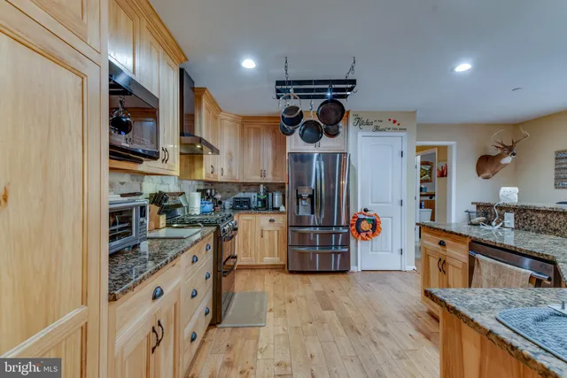 a kitchen with stainless steel appliances granite countertop lots of counter top space