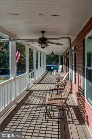 a view of swimming pool with outdoor seating and covered with trees