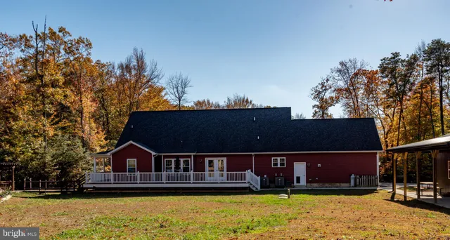 a balcony with wooden floor table and chairs