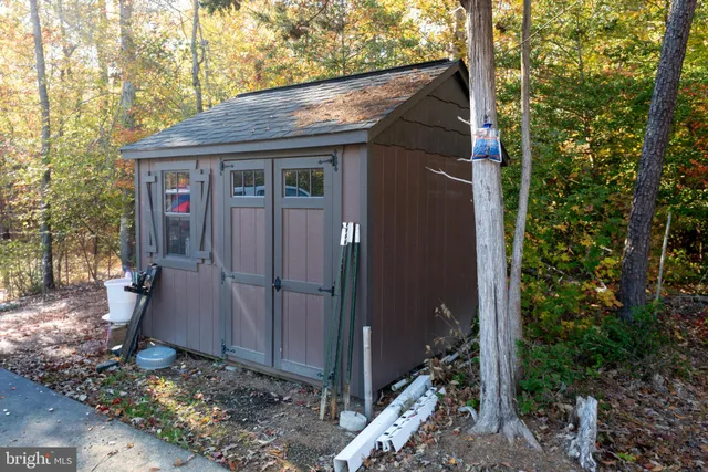 a view of a patio with table and chairs with wooden floor and fence