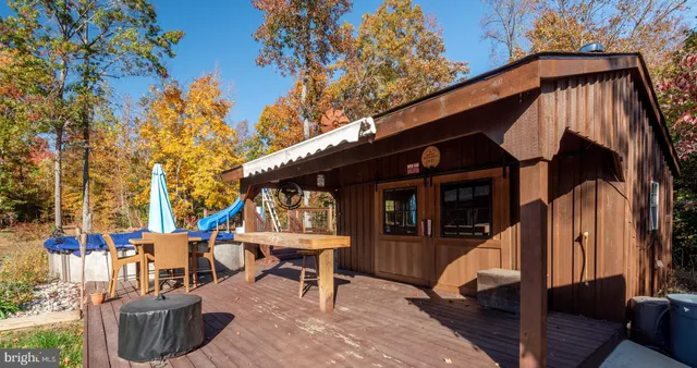 a view of a backyard with a table and chairs