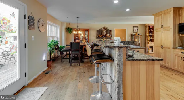 a kitchen with granite countertop a refrigerator stove top oven and sink