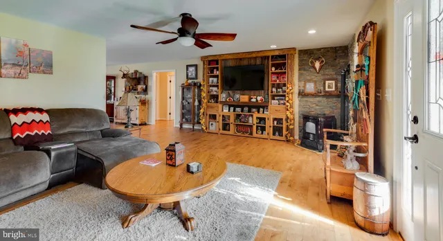 a living room with furniture and wooden floor
