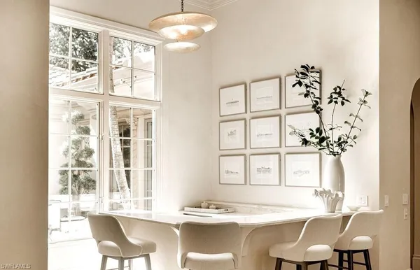 a view of a dining room with furniture and chandelier