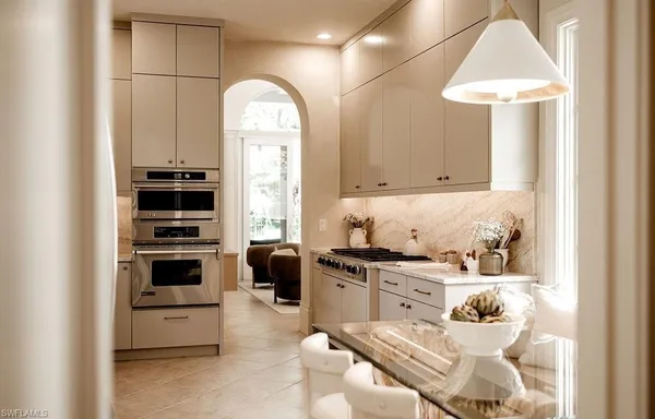 a kitchen with stainless steel appliances a stove a sink and a refrigerator