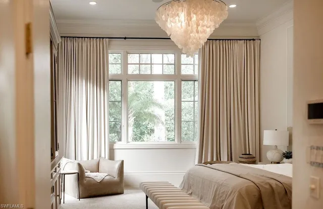 a bedroom with a bed and a chandelier