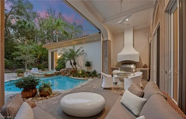 a view of a chairs and table in backyard of a house