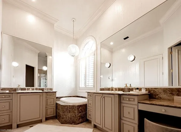 a bathroom with a double vanity sink a mirror a toilet and a window