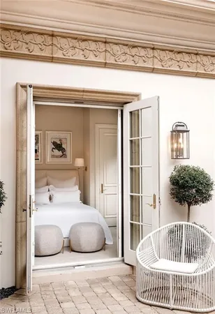 a bedroom with a bed and walk in closet with wooden floor