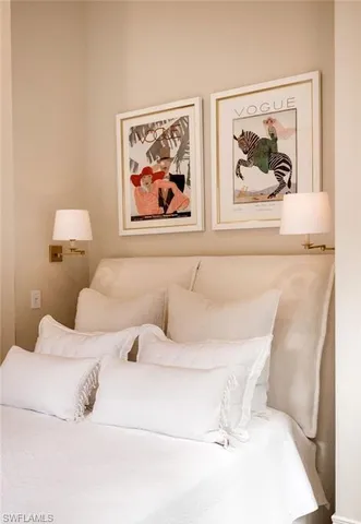 a bedroom with a bed and wall painting