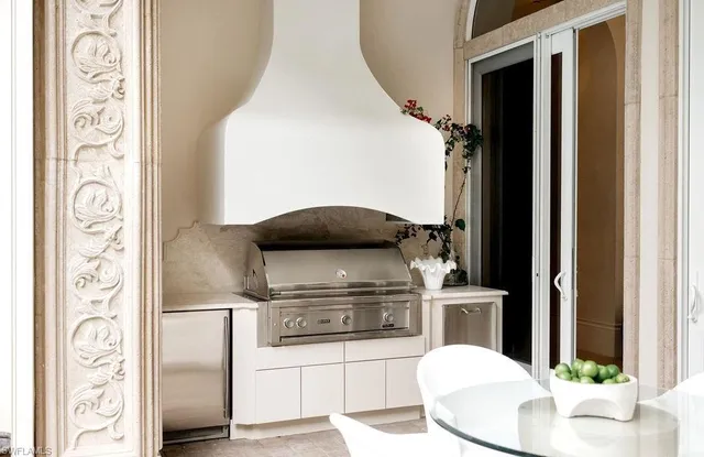 a kitchen with stainless steel appliances kitchen island granite countertop a refrigerator and a stove