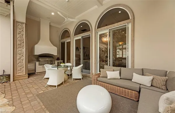 a living room with furniture a lamp and a chandelier