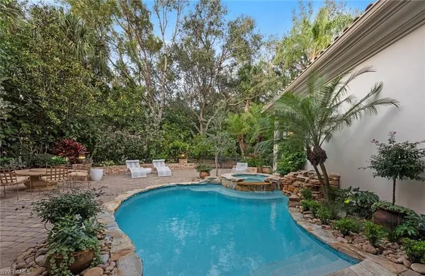 a view of a backyard with swimming pool