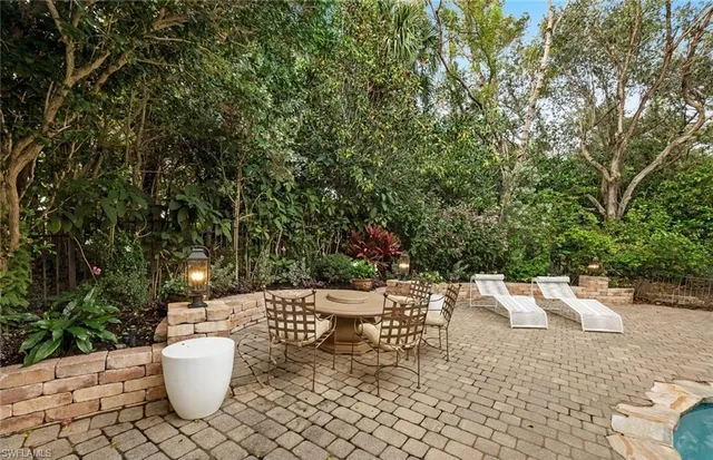 a view of a patio with a chairs and potted plants