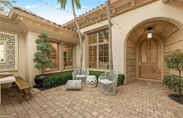 a view of a door of the house with outdoor seating