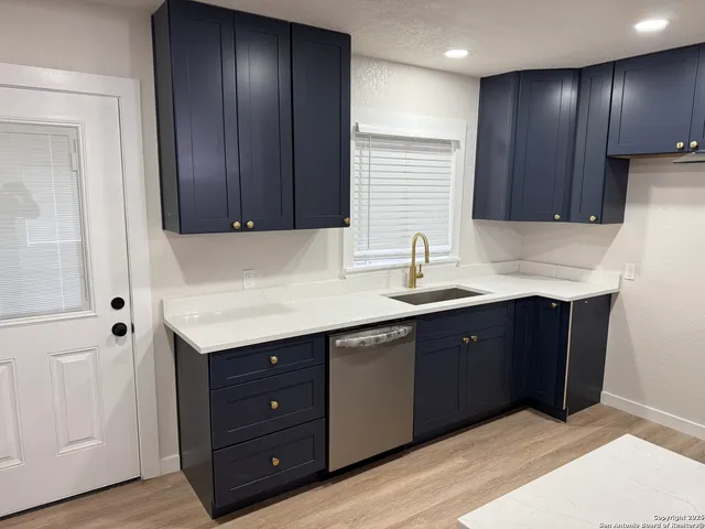 a kitchen with wooden cabinets and a sink