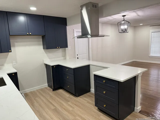 a kitchen with a cabinets and chandelier